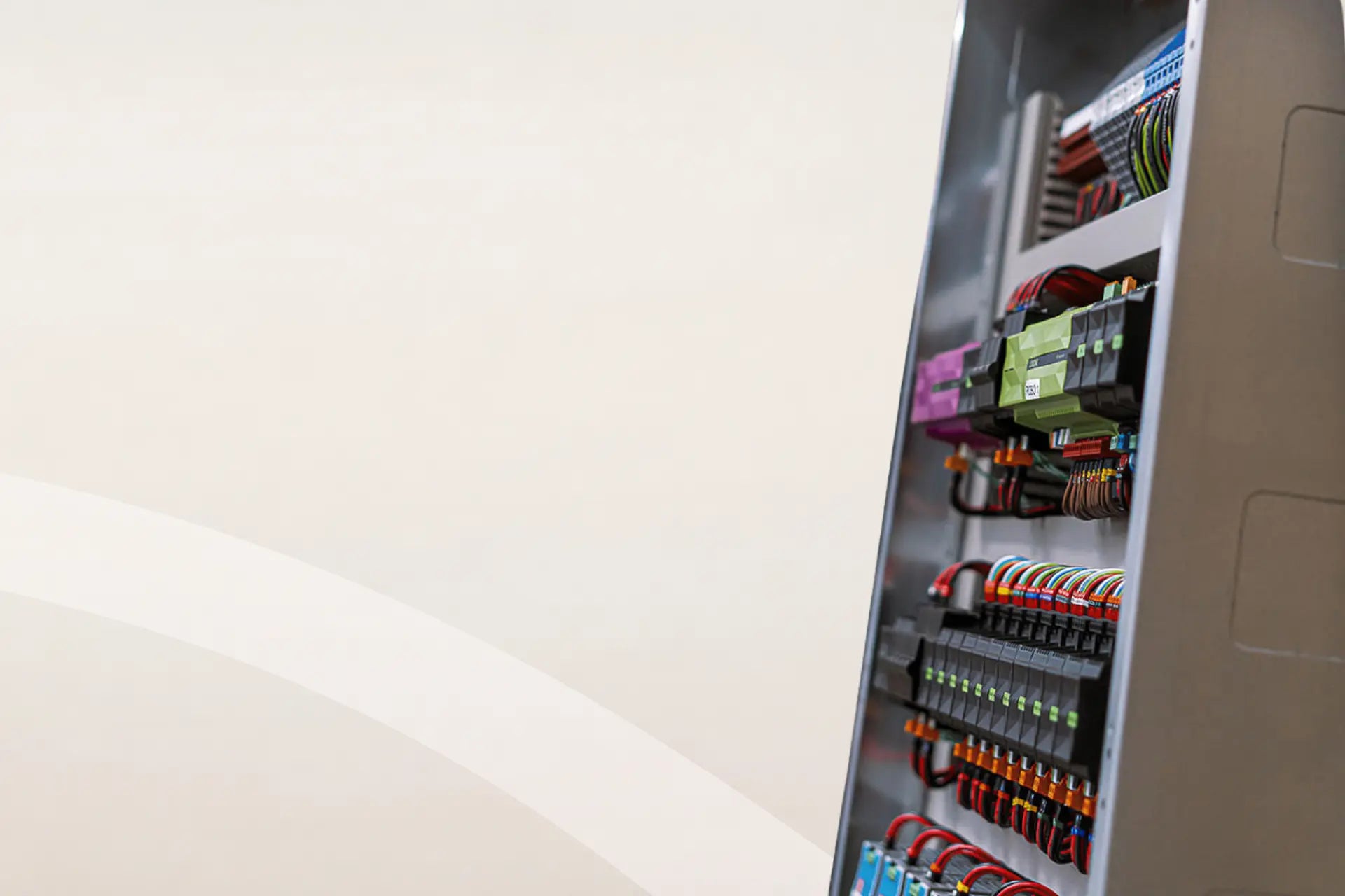 Zijaanzicht van een professioneel bekabeld elektriciteitsbord van Kompanjonn met kleurgecodeerde bedrading en domotica-modules voor een overzichtelijke zelfbouw-installatie